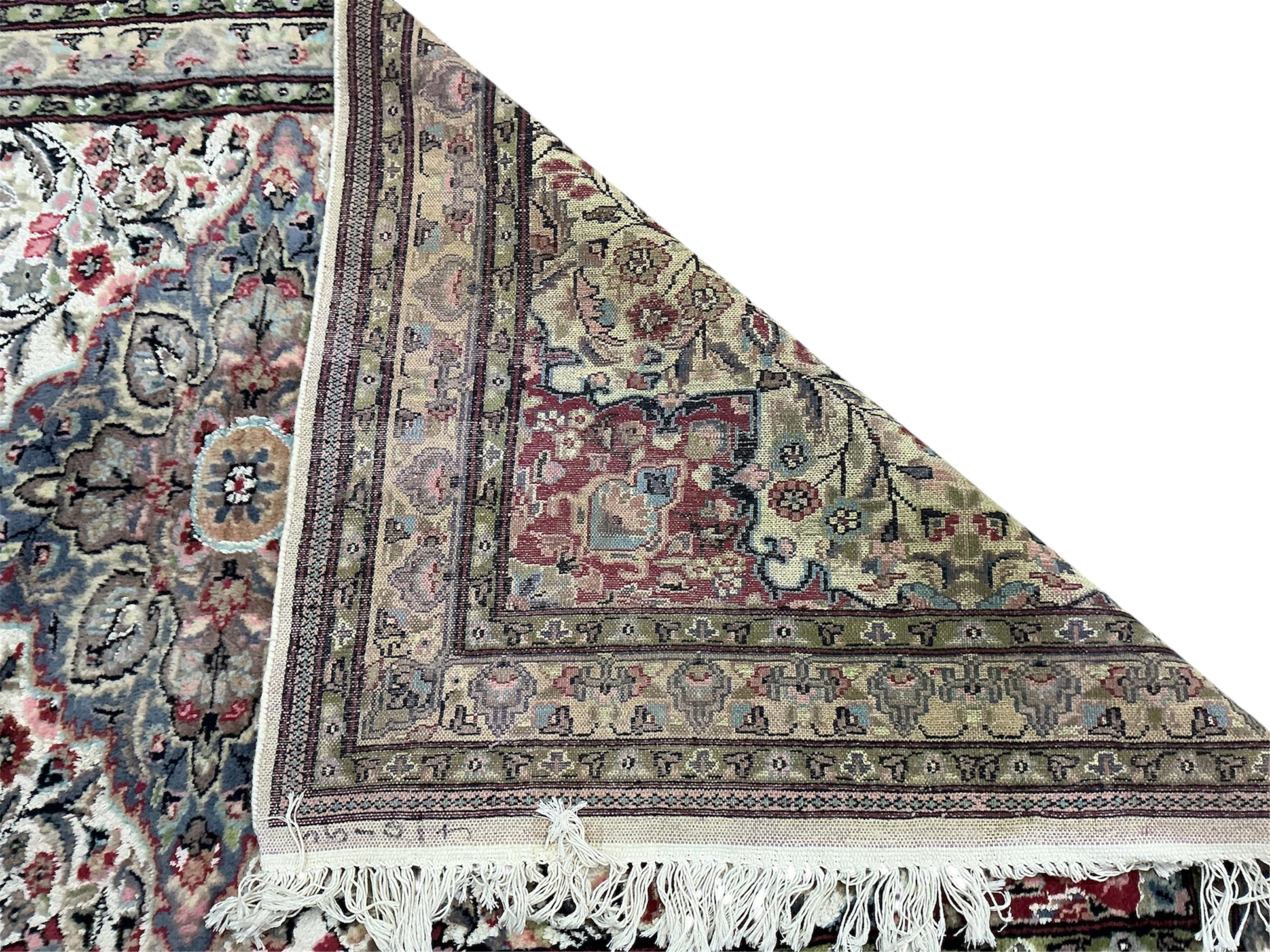A Pakistan ivory ground part silk medallion rug, 196cm x 125cm